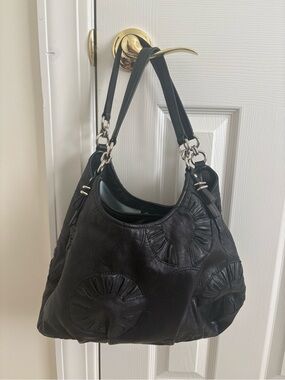 Coach Black Leather Shoulder Bag with Circular Appliqué